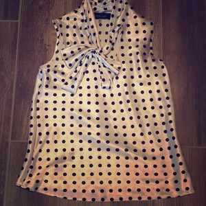 White blouse with black polka dots with necktie.